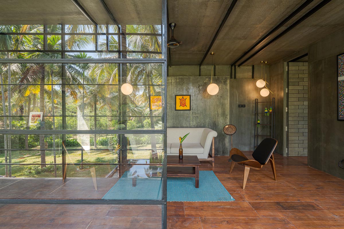 Parallax designs black weekend house raised on slender stilts within coconut trees in Bangalore