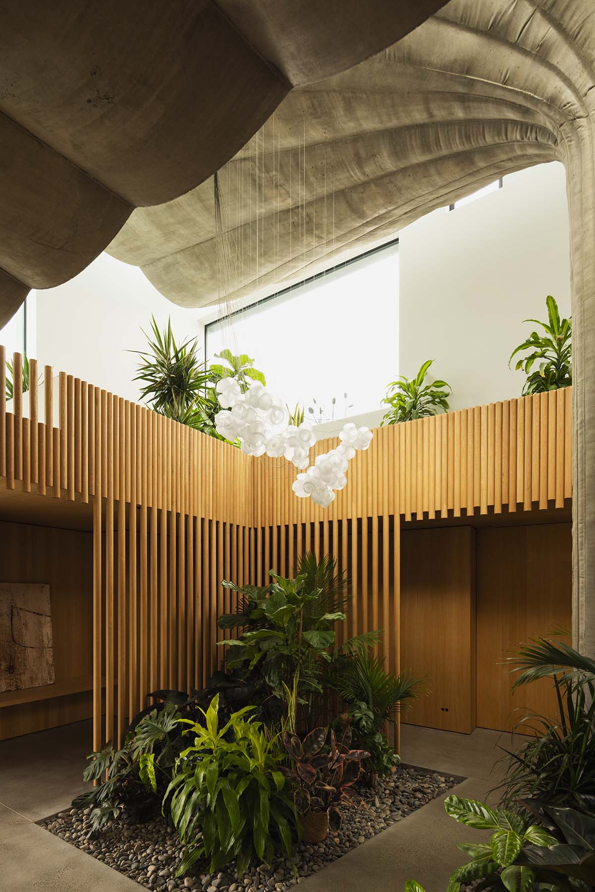 Omer Arbel shapes family home around monumental lily pad columns on a hayfield in Canada