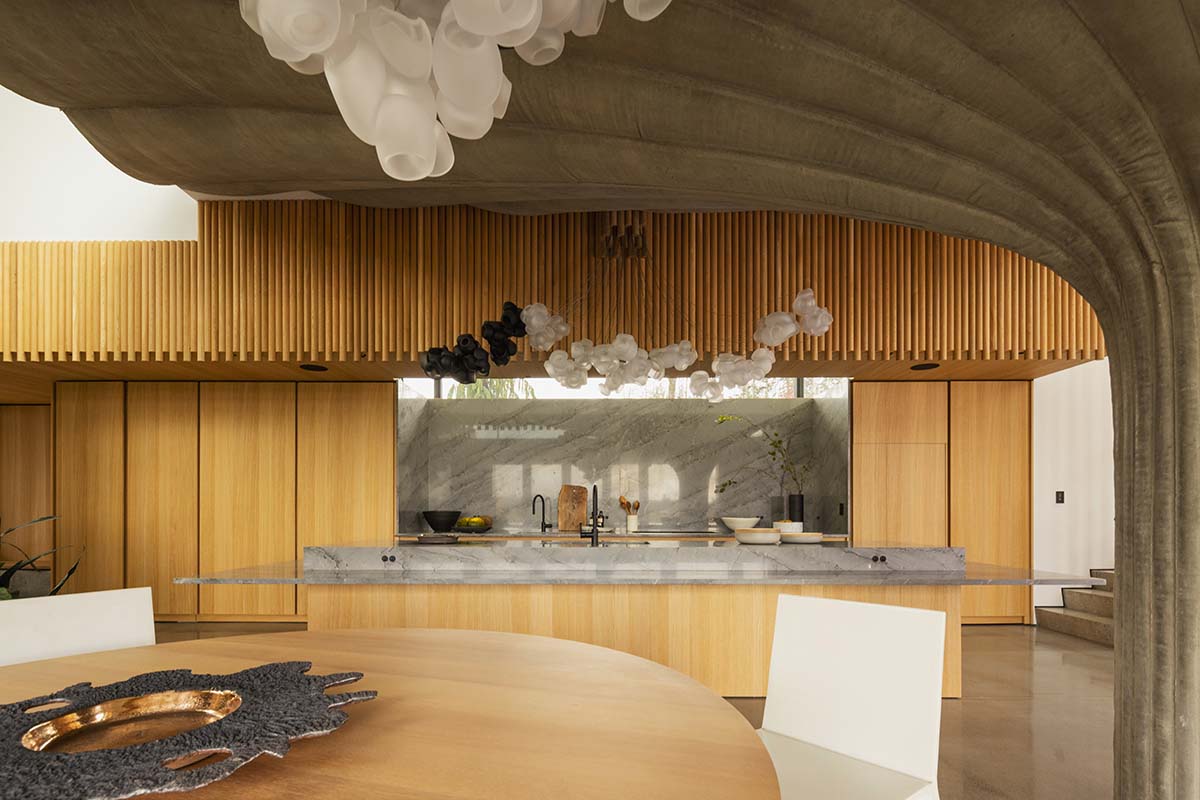 Omer Arbel shapes family home around monumental lily pad columns on a hayfield in Canada