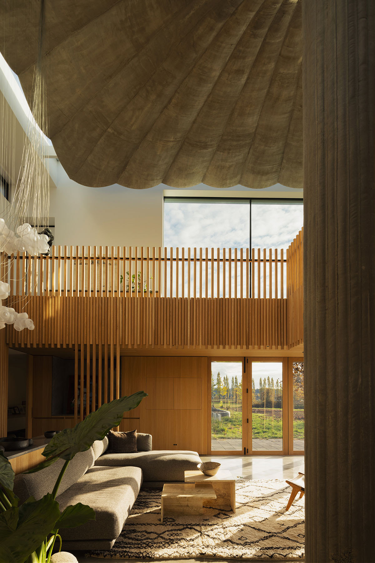 Omer Arbel shapes family home around monumental lily pad columns on a hayfield in Canada