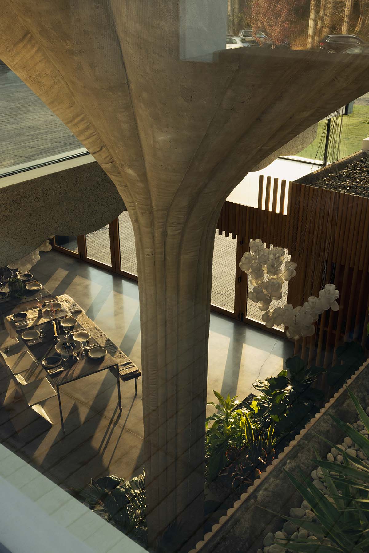 Omer Arbel shapes family home around monumental lily pad columns on a hayfield in Canada