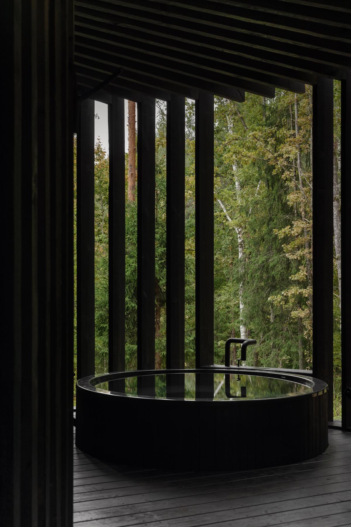 OPEN AD designs black timber Wool Sauna at a resort in Latvia 