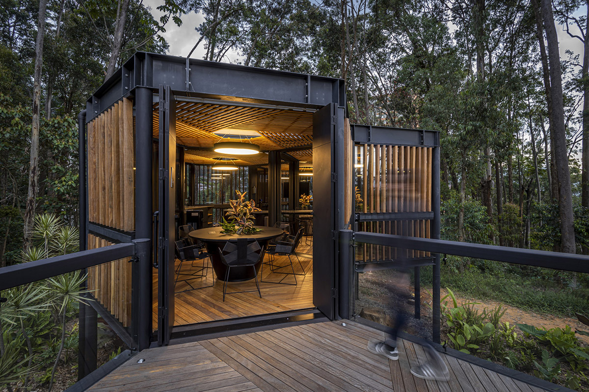 Experience rooms made of hexagonal units are raised on stilts in a forest of Medellín, Colombia