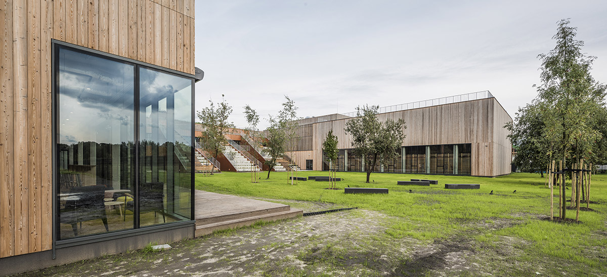 Huge tribunes invite students to sit and experience the courtyard in Warsaw's Akademeia High School
