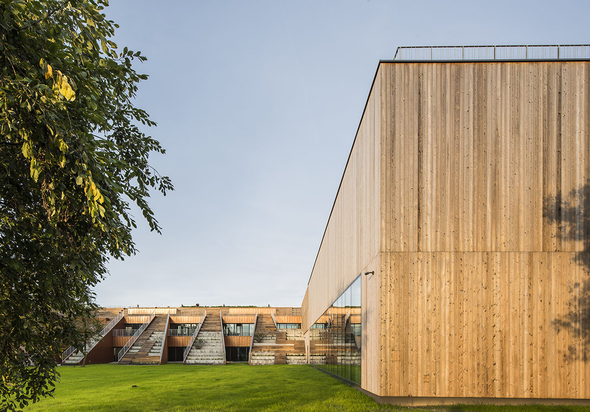 Huge tribunes invite students to sit and experience the courtyard in Warsaw's Akademeia High School