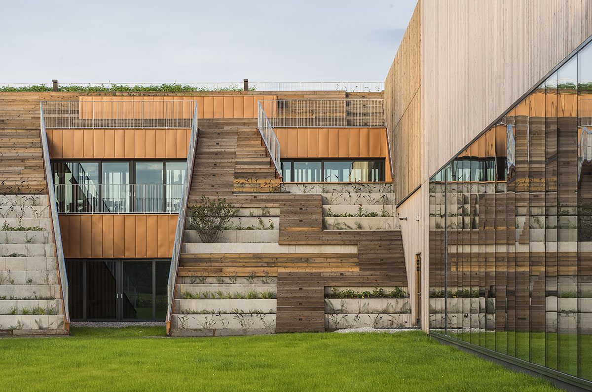 Huge tribunes invite students to sit and experience the courtyard in Warsaw's Akademeia High School