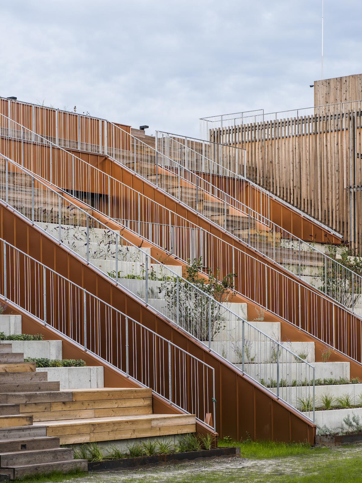Huge tribunes invite students to sit and experience the courtyard in Warsaw's Akademeia High School