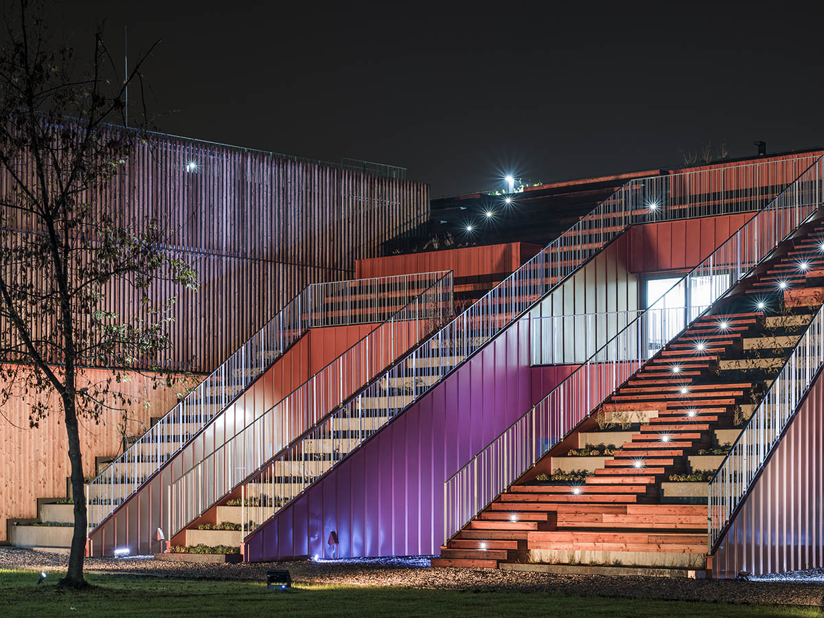 Huge tribunes invite students to sit and experience the courtyard in Warsaw's Akademeia High School