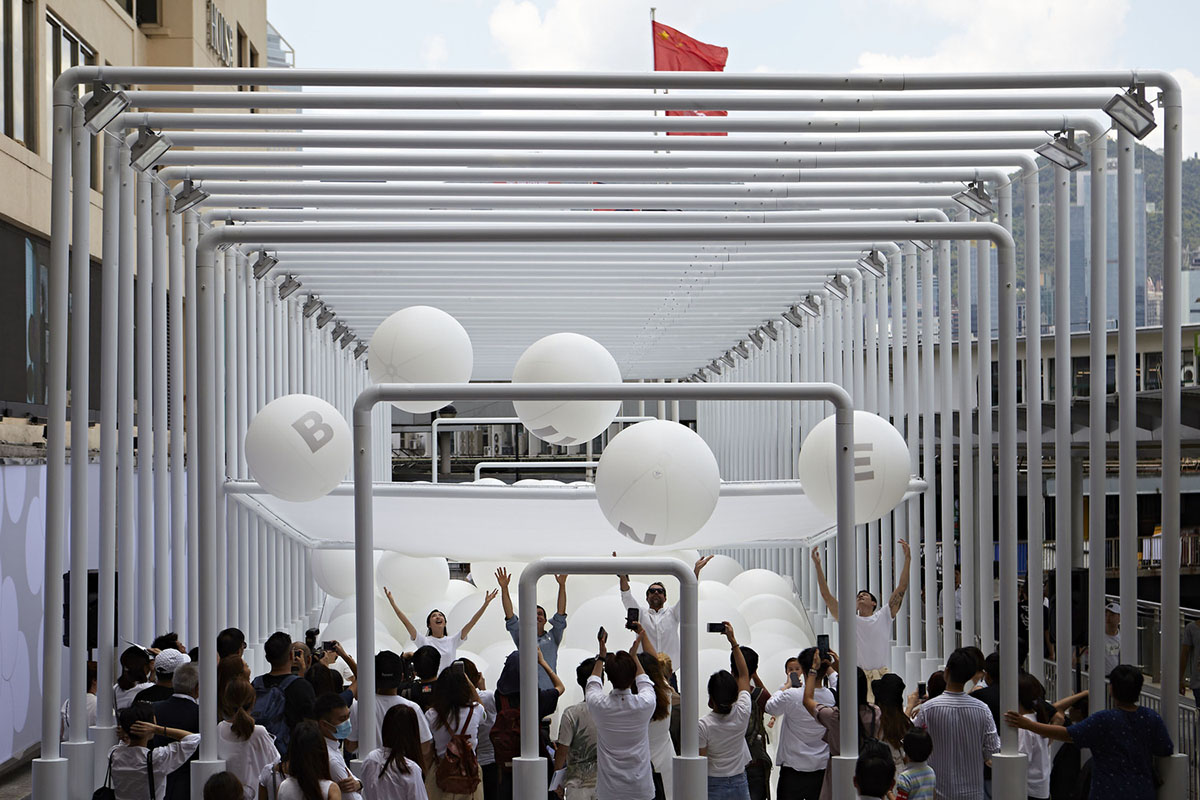 Snarkitecture fills giant steel cage with white bouncy balls at Harbour City of Hong Kong