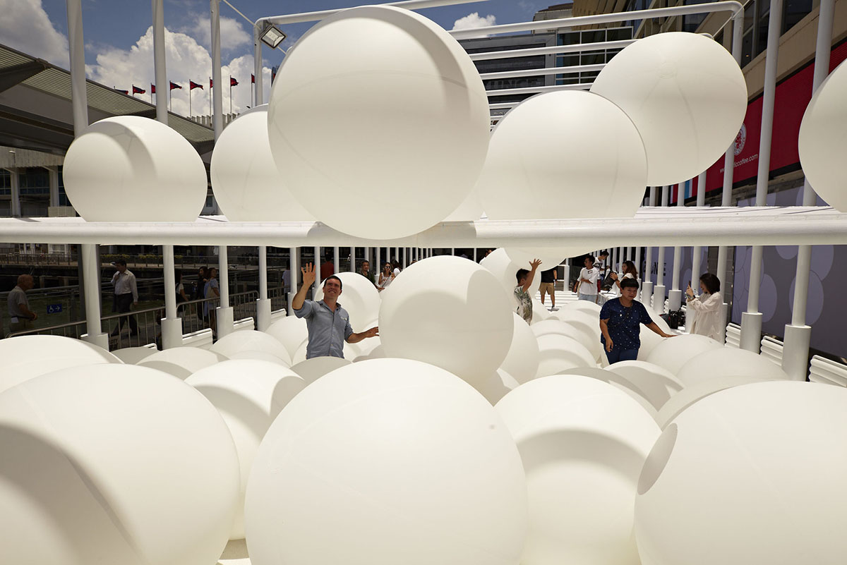 Snarkitecture fills giant steel cage with white bouncy balls at Harbour City of Hong Kong