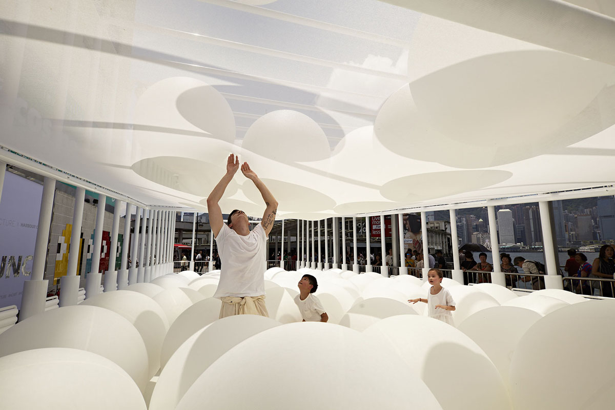 Snarkitecture fills giant steel cage with white bouncy balls at Harbour City of Hong Kong