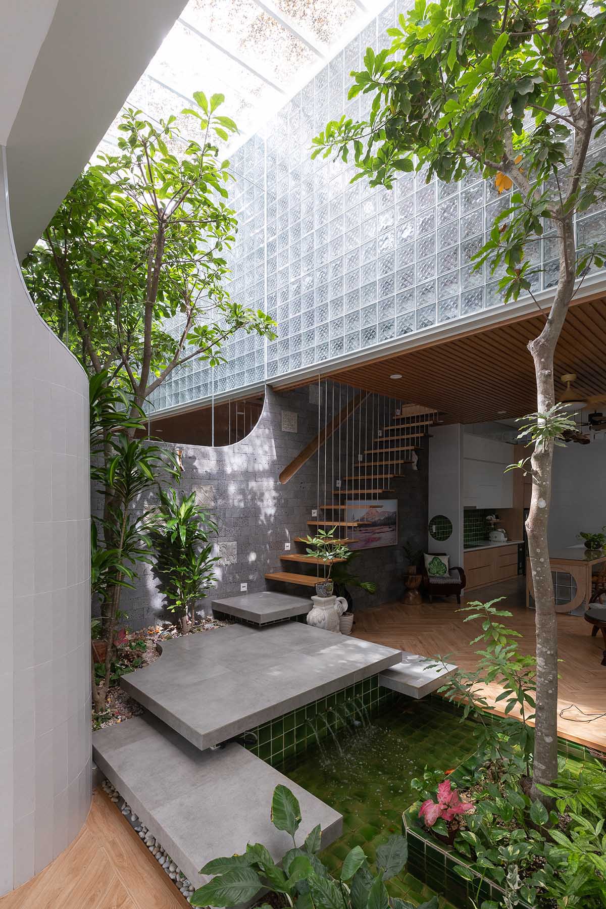 CoCo House, inspired by animated film, is clad in glass brick façade with wavy patterns in Vietnam