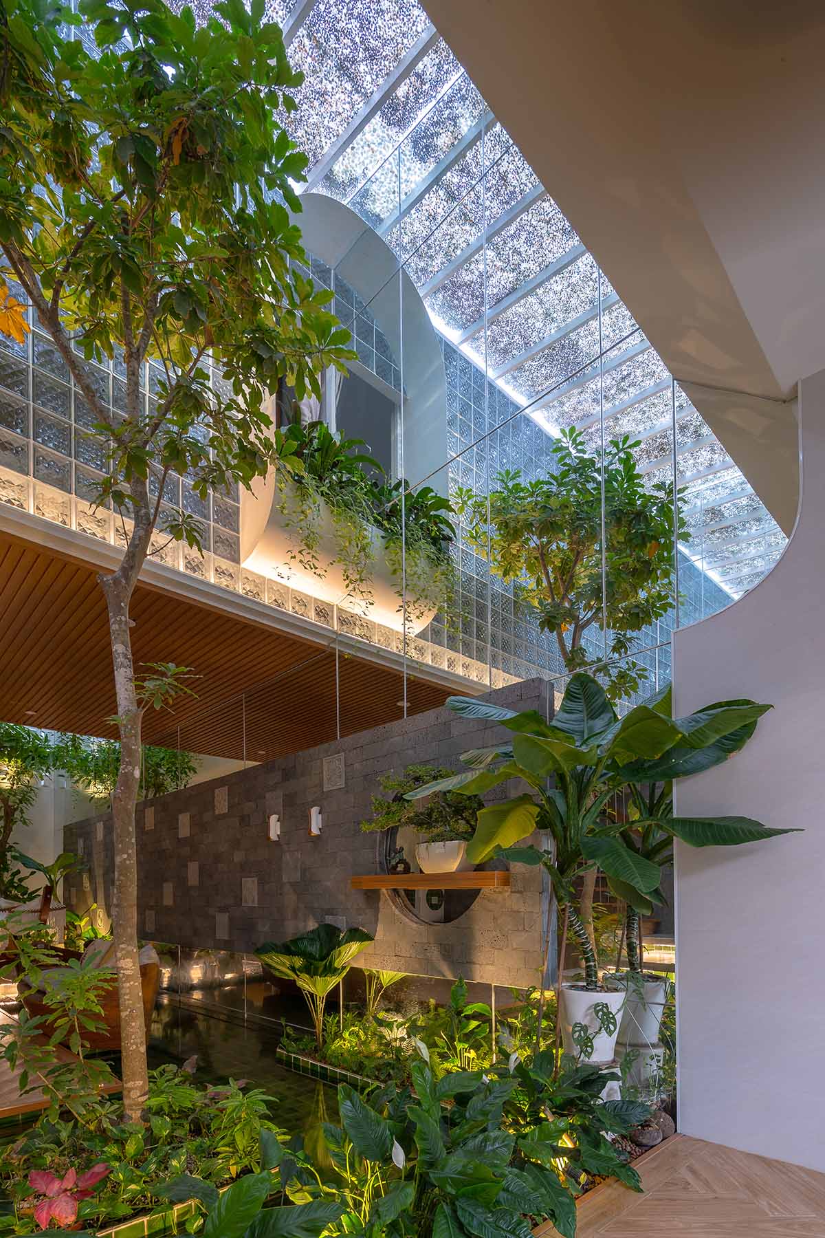 CoCo House, inspired by animated film, is clad in glass brick façade with wavy patterns in Vietnam