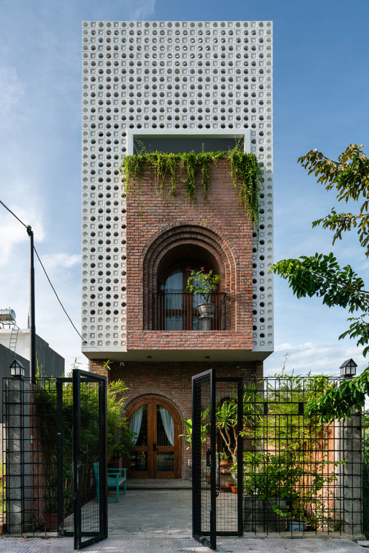 Artistic brick doorways and skylights give more depth to this Vietnamese house designed by Coi Design