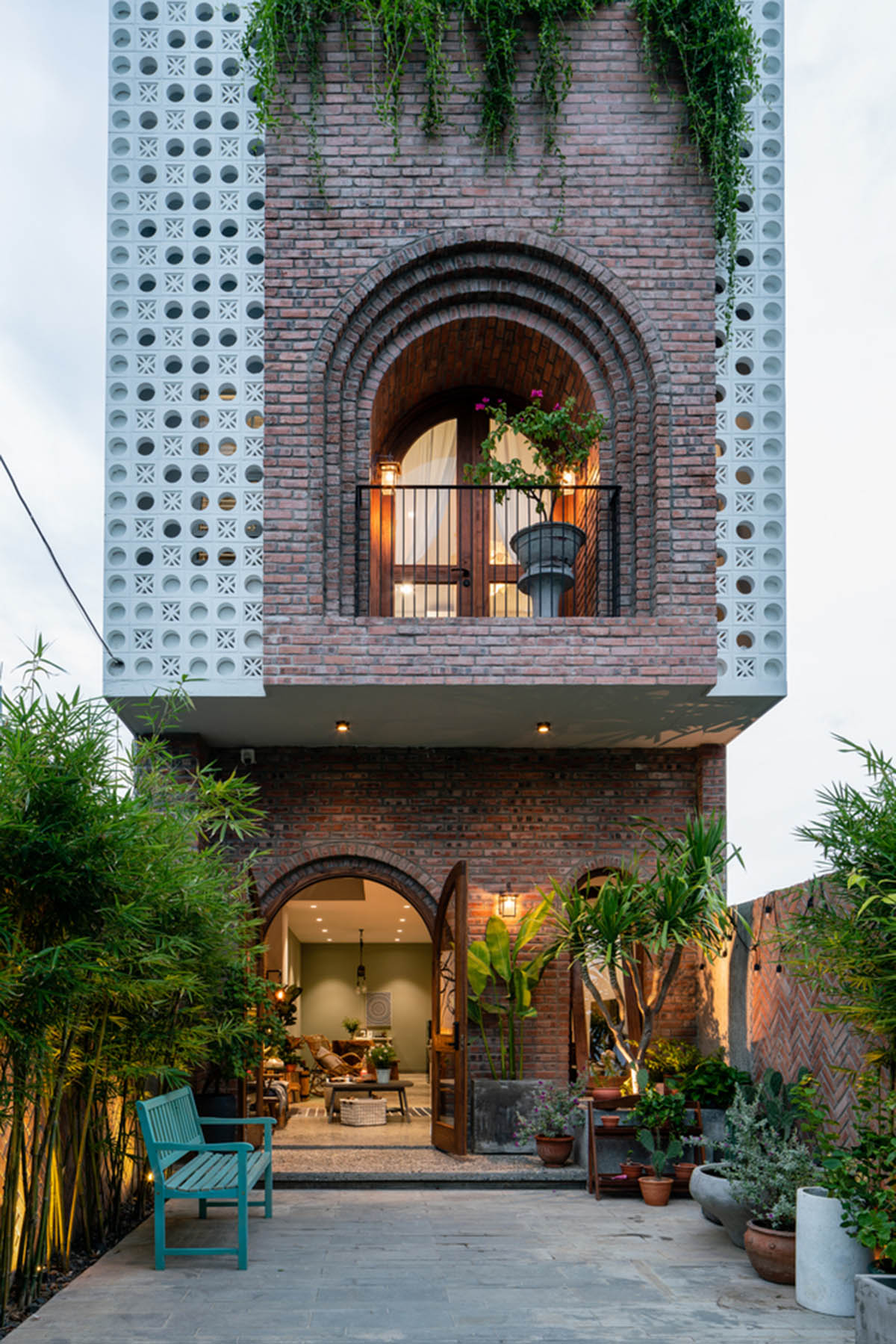 Artistic brick doorways and skylights give more depth to this Vietnamese house designed by Coi Design