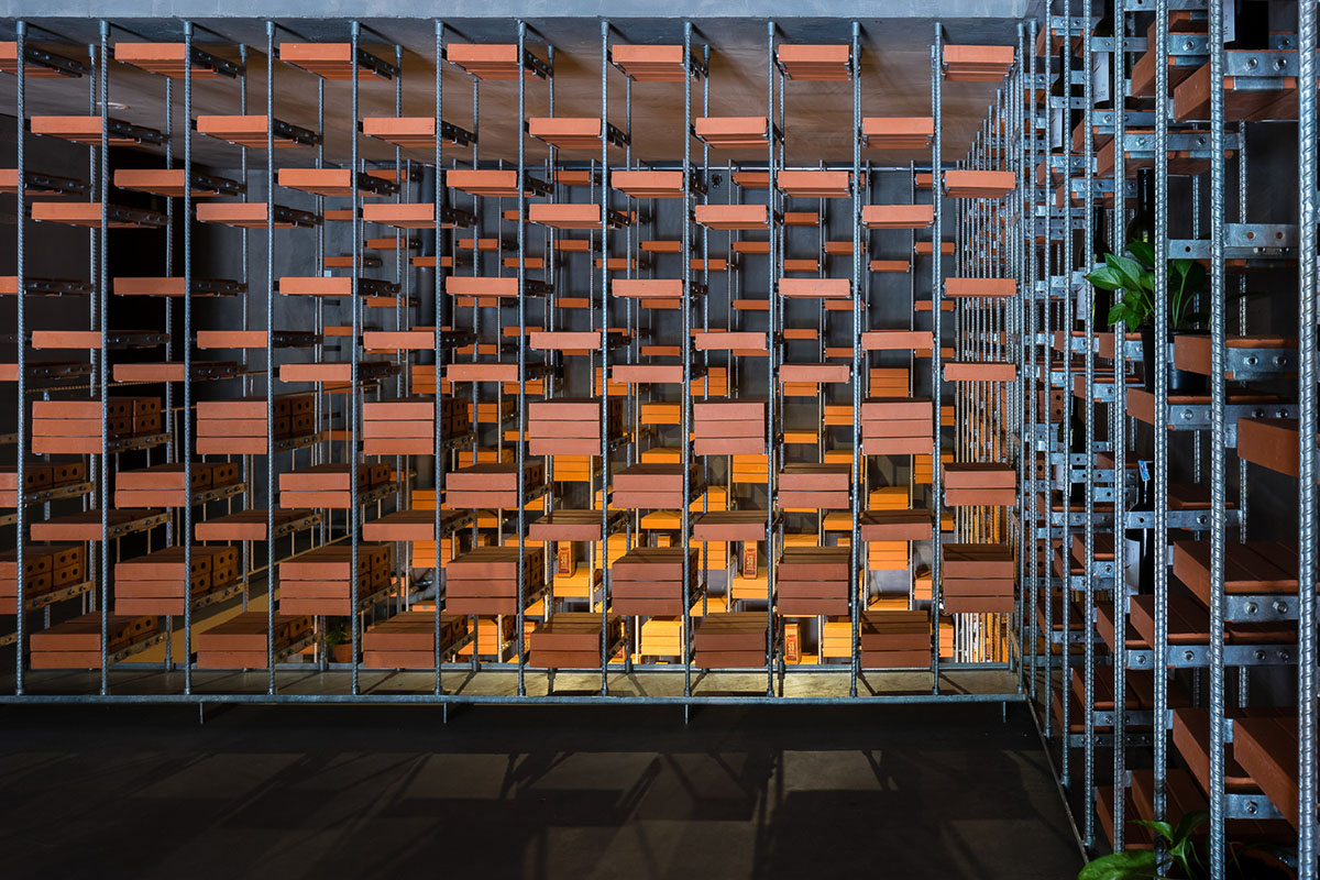 Tropical Space uses brick shelves to convert old house into an organicare showroom in Vietnam