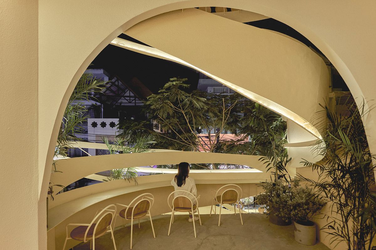 September Cafe is designed to look like a bird's nest with curved steel stripes in Vietnam