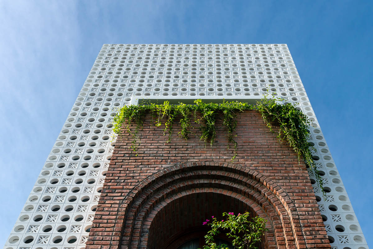 Artistic brick doorways and skylights give more depth to this Vietnamese house designed by Coi Design