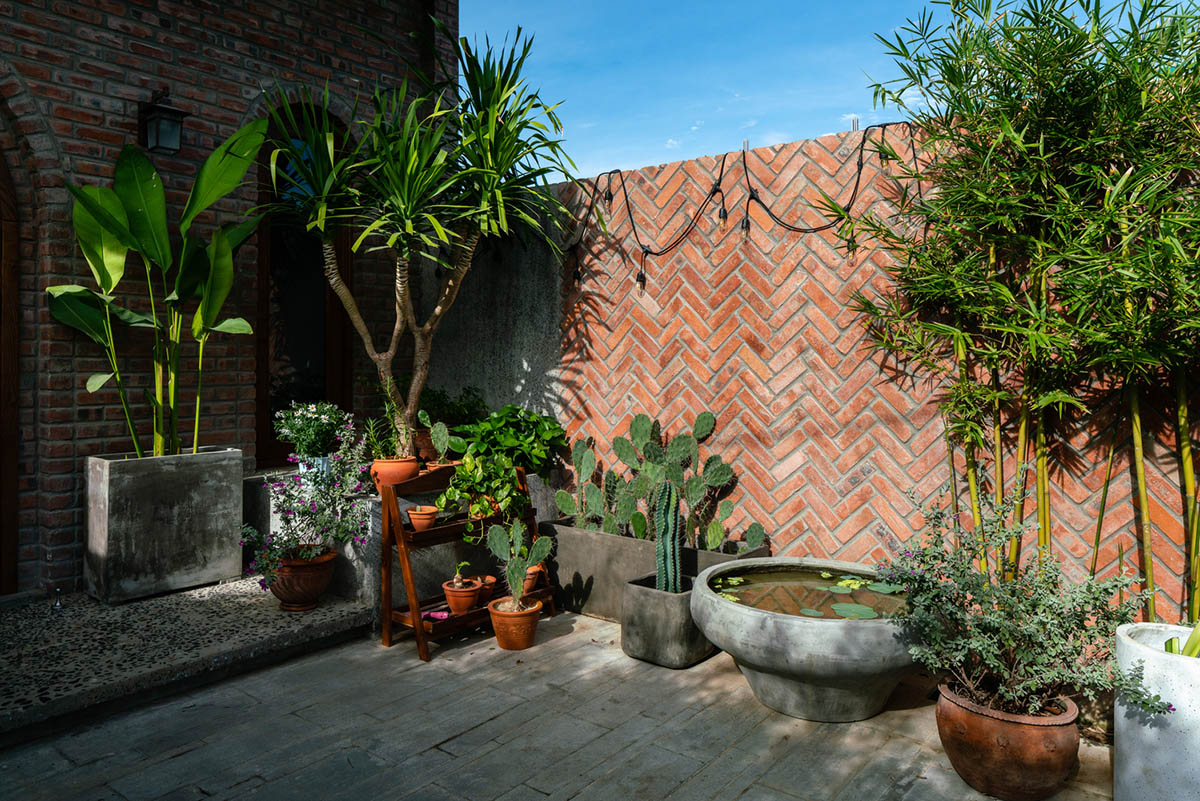 Artistic brick doorways and skylights give more depth to this Vietnamese house designed by Coi Design