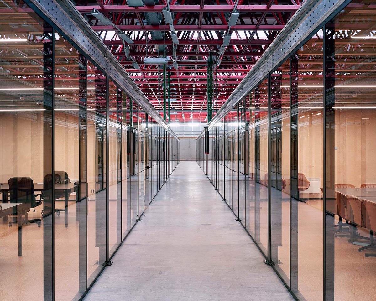 Traumnovelle converts industrial building into a workspace with pinkish steel ceiling in Belgium 