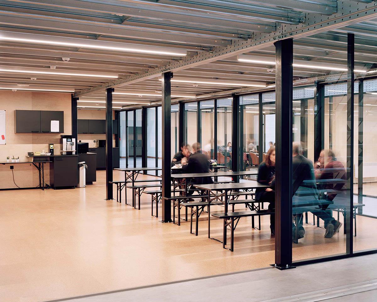 Traumnovelle converts industrial building into a workspace with pinkish steel ceiling in Belgium 