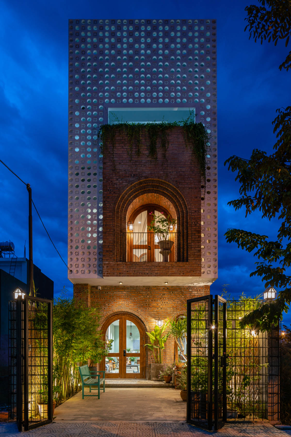 Artistic brick doorways and skylights give more depth to this Vietnamese house designed by Coi Design