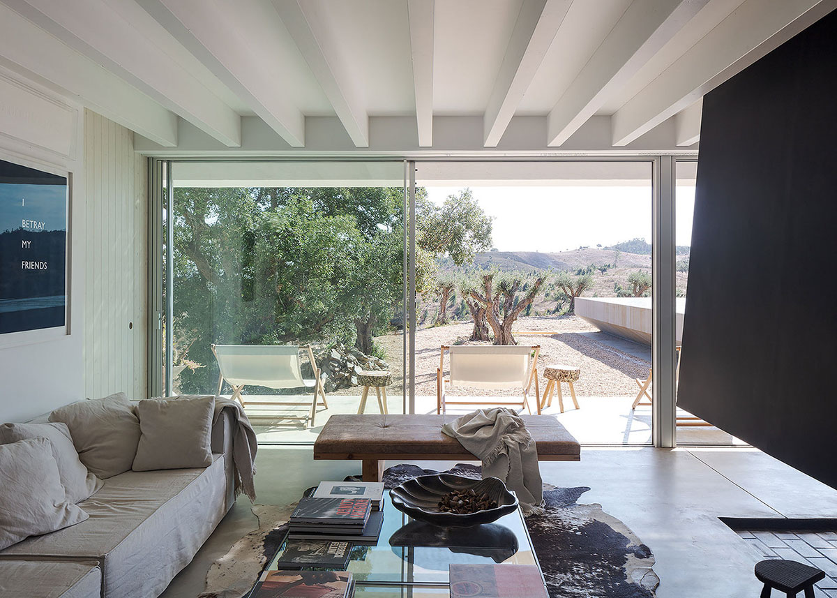 Low-profiled whitewashed stone walls wrap living units of Casa da Volta by PROMONTORIO and João Cravo