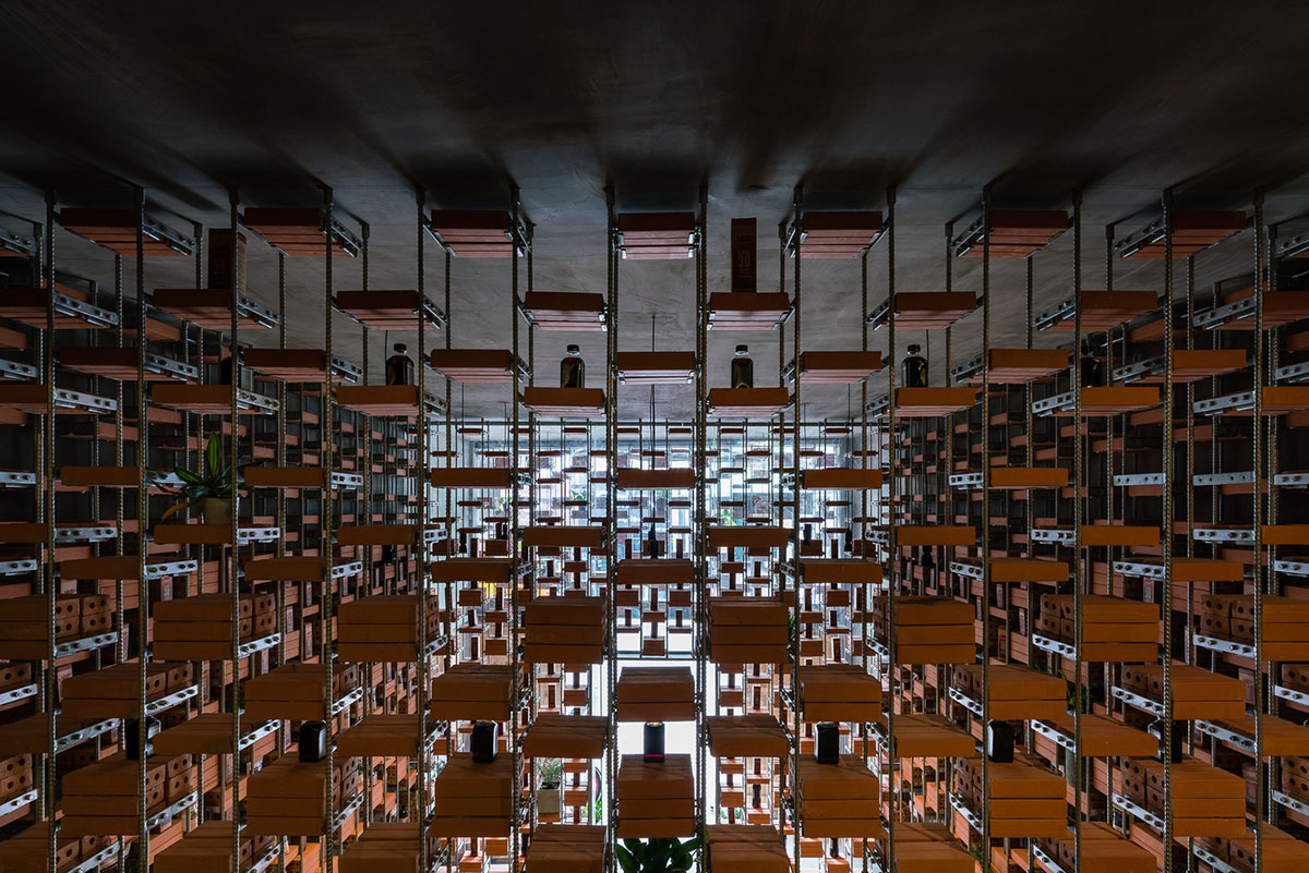 Tropical Space uses brick shelves to convert old house into an organicare showroom in Vietnam