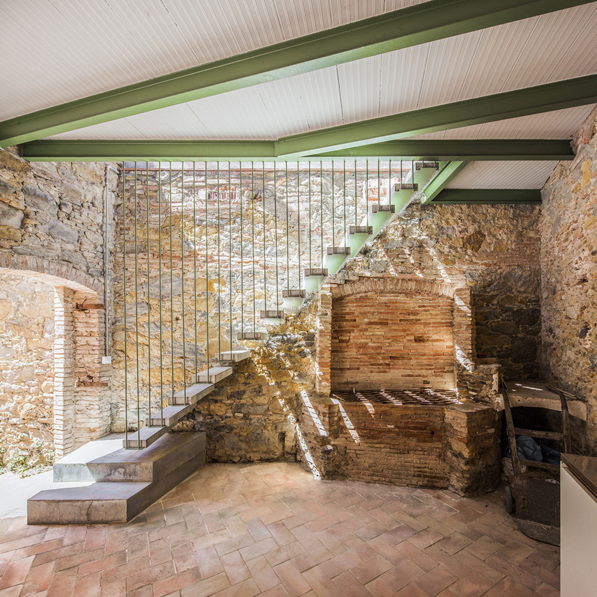 Anna & Eugeni Bach converts former chocolate factory into residence with stone walls in Spain