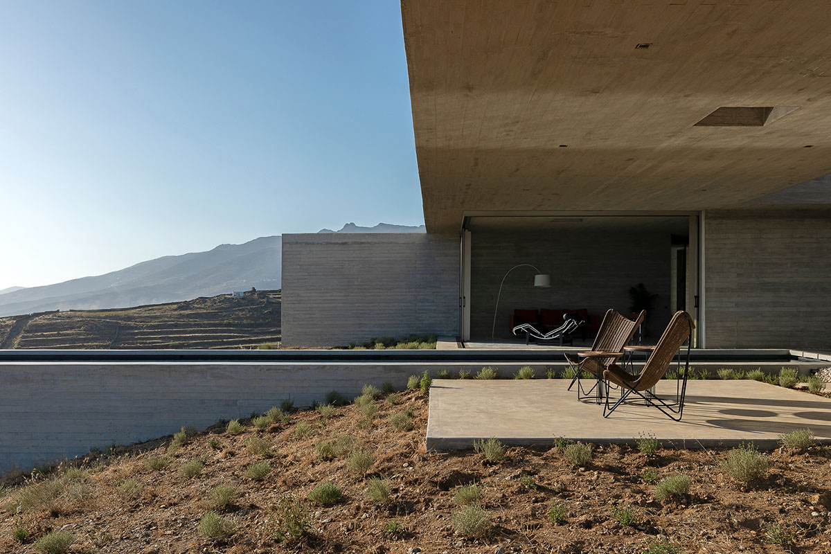 Swimming pool is bravely extended from inside of this concrete house towards endless view in Tinos