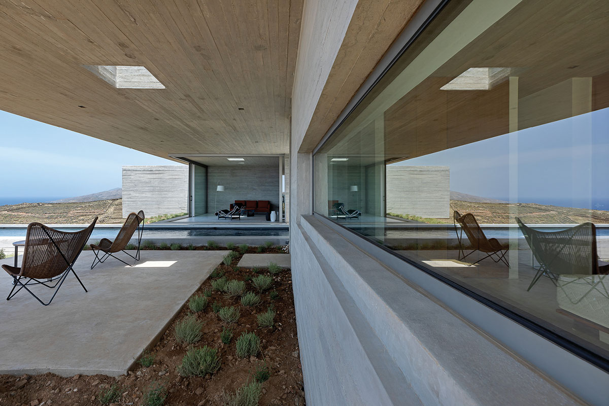 Swimming pool is bravely extended from inside of this concrete house towards endless view in Tinos