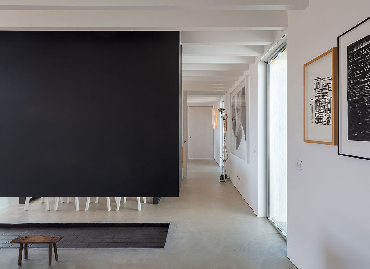 Low-profiled whitewashed stone walls wrap living units of Casa da Volta by PROMONTORIO and João Cravo