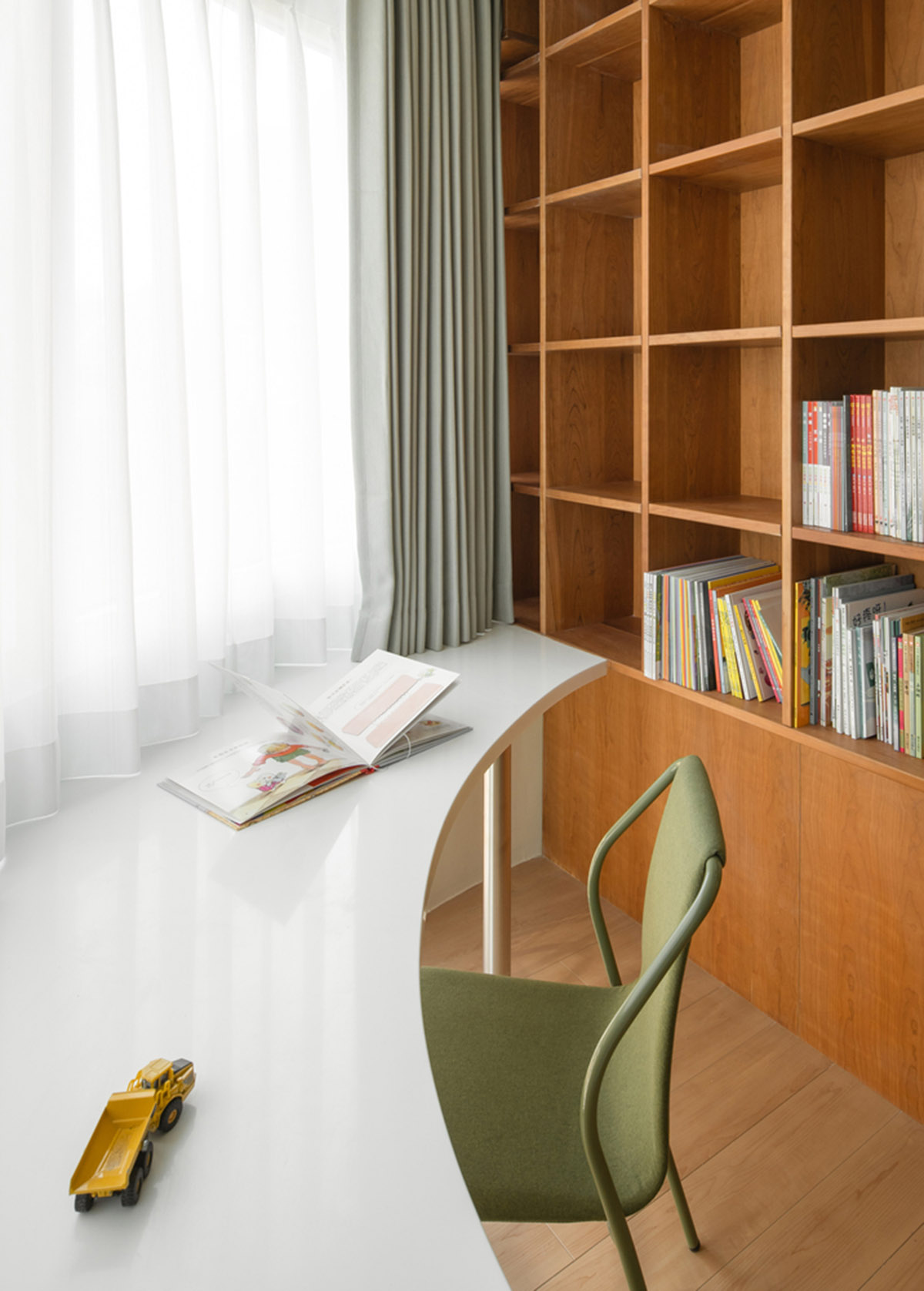 Cherry wood bookcase shapes this house by Atelier D+Y to create flexible interior in Shanghai