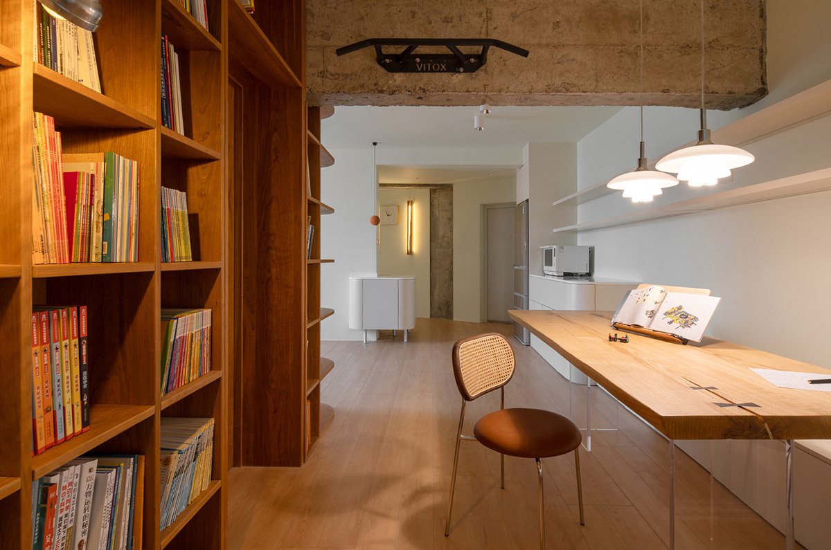 Cherry wood bookcase shapes this house by Atelier D+Y to create flexible interior in Shanghai
