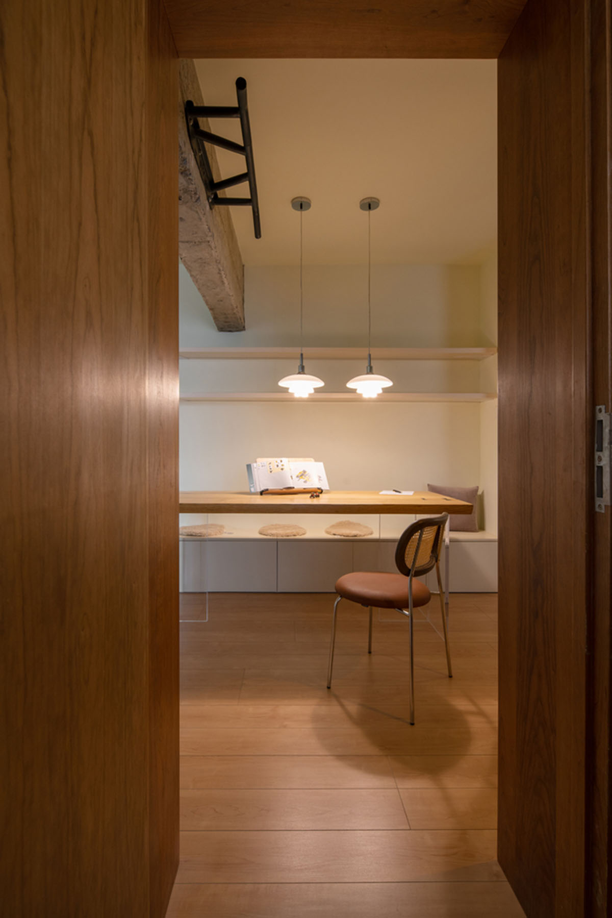 Cherry wood bookcase shapes this house by Atelier D+Y to create flexible interior in Shanghai