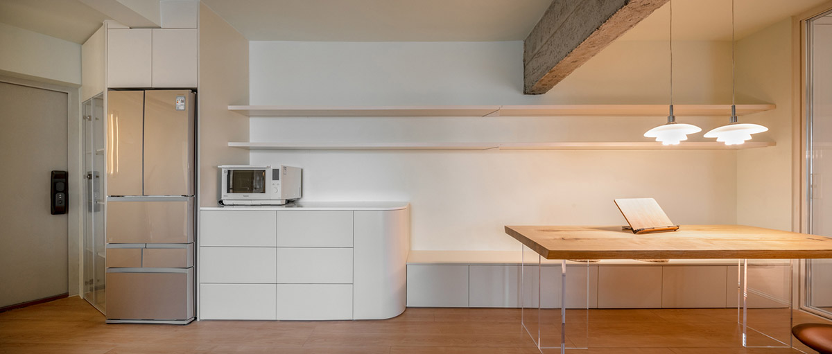 Cherry wood bookcase shapes this house by Atelier D+Y to create flexible interior in Shanghai
