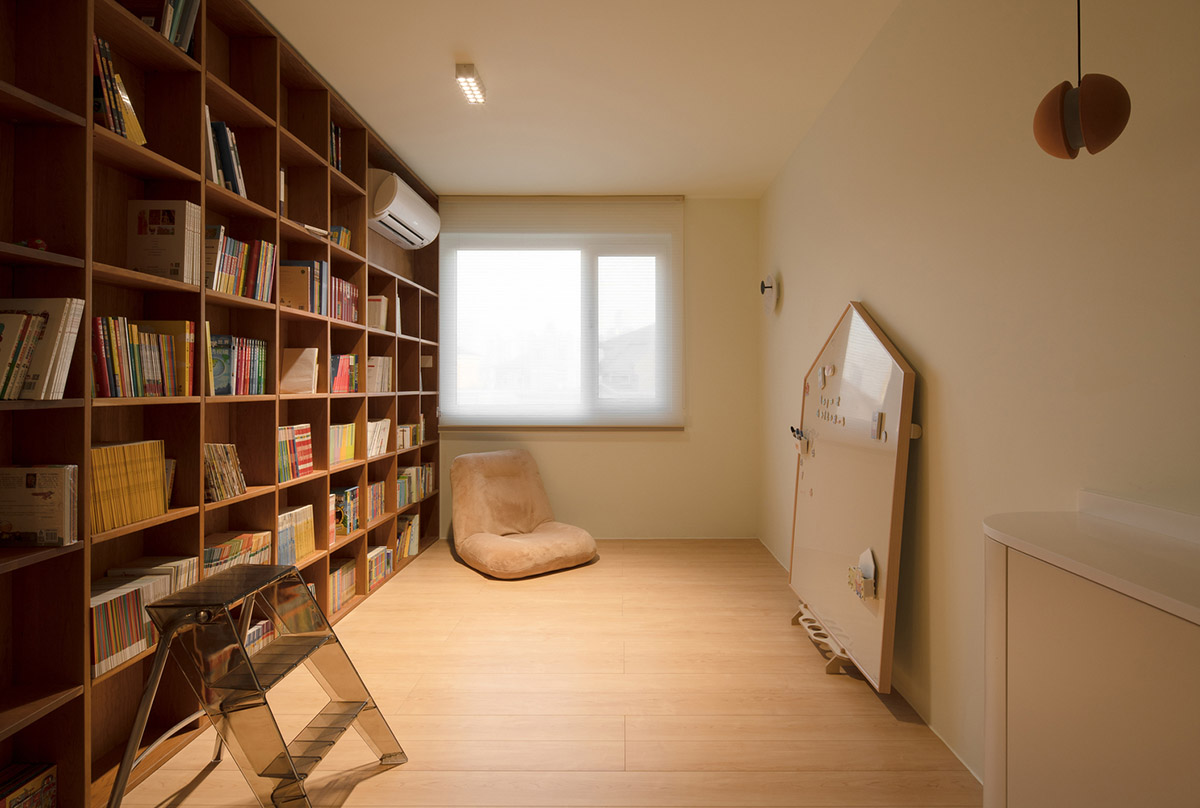 Cherry wood bookcase shapes this house by Atelier D+Y to create flexible interior in Shanghai