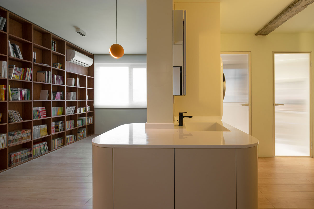Cherry wood bookcase shapes this house by Atelier D+Y to create flexible interior in Shanghai