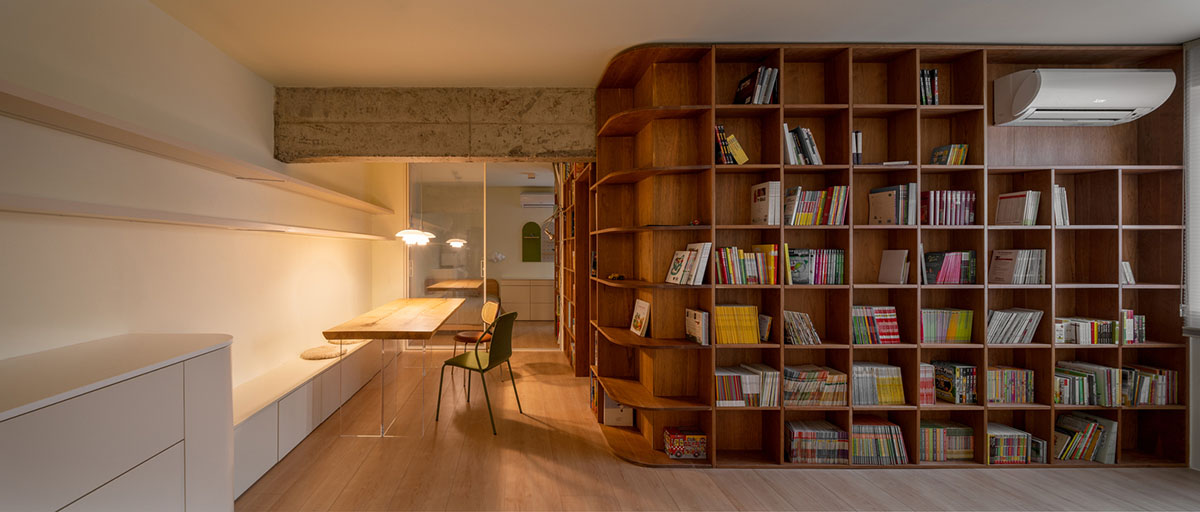 Cherry wood bookcase shapes this house by Atelier D+Y to create flexible interior in Shanghai