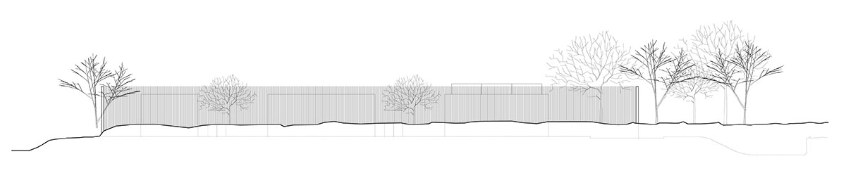 Palisade House is wrapped by a long palisade in fir wood to protect dunes in Troia, Portugal