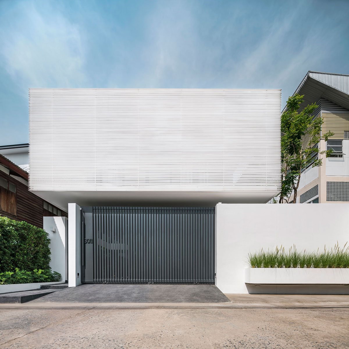 Anonym Studio completes Y House with white louvres in the old neighborhood of Thailand