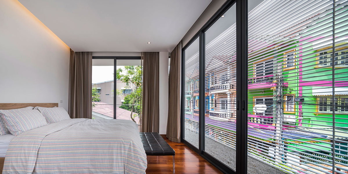 Anonym Studio completes Y House with white louvres in the old neighborhood of Thailand