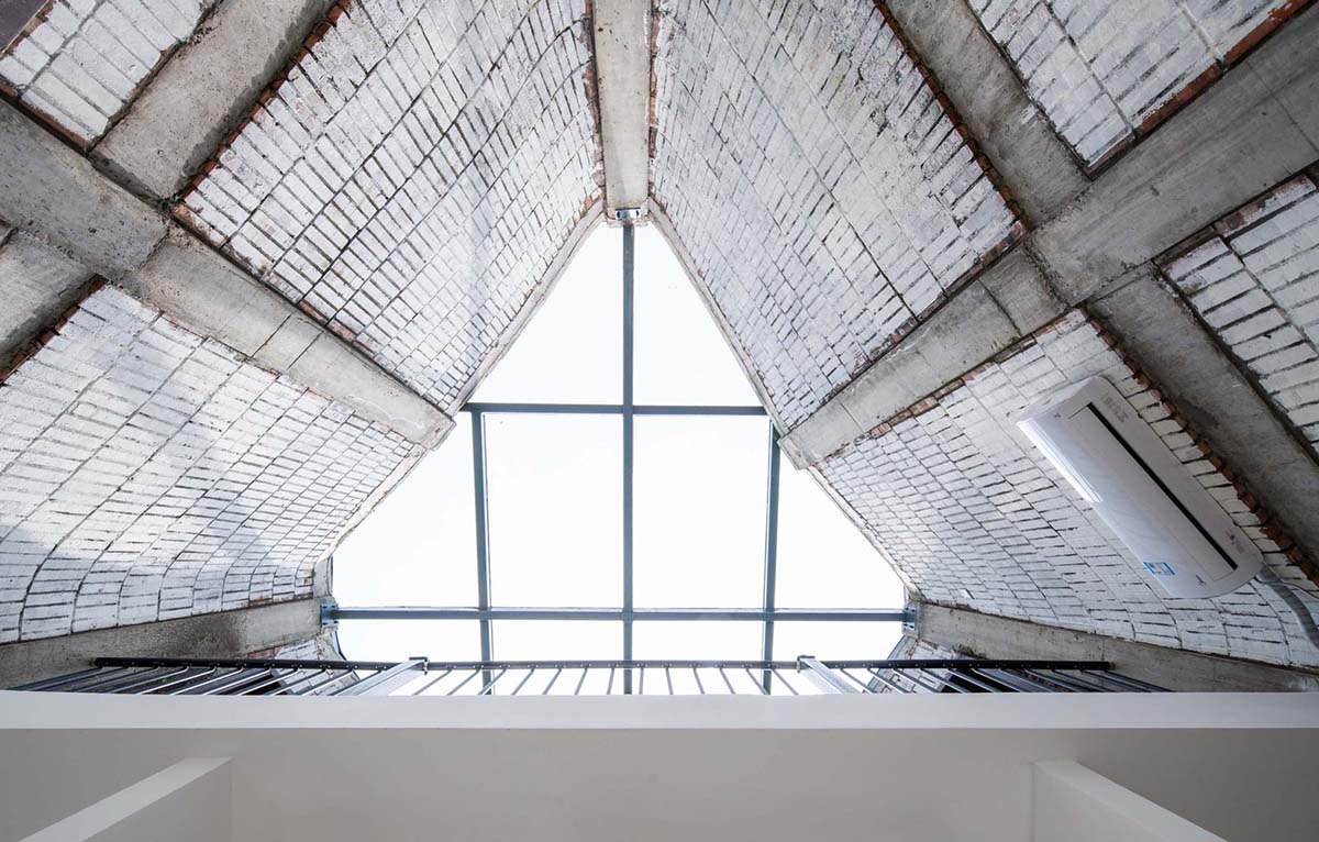 Hyperbolic vertical grottos are activated by a network of floating wooden bridges in China