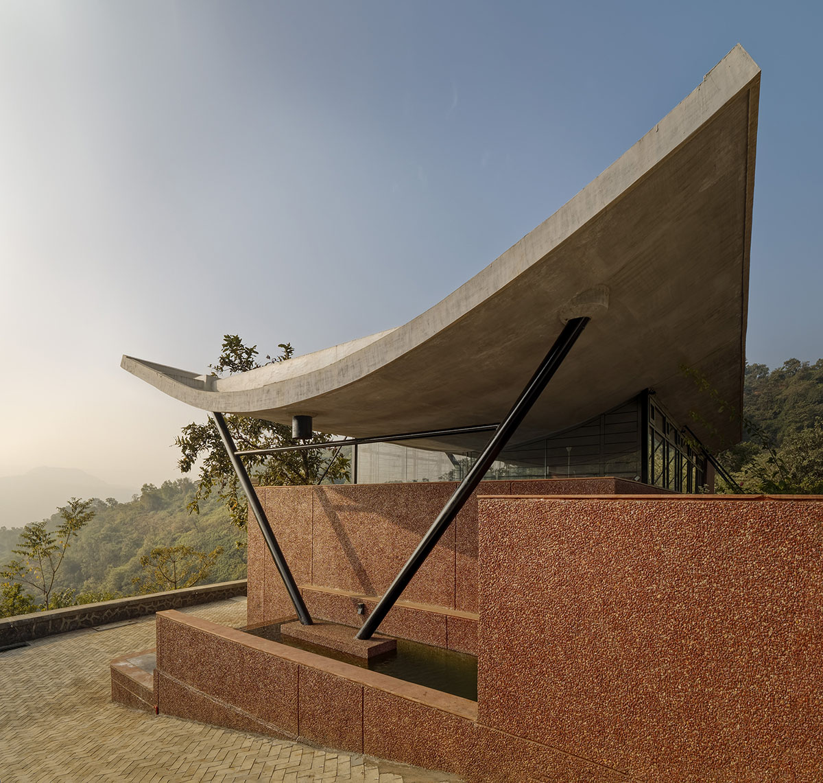 The Cove House by Red Brick Studio benefits from hilly slope and captures picturesque views in India