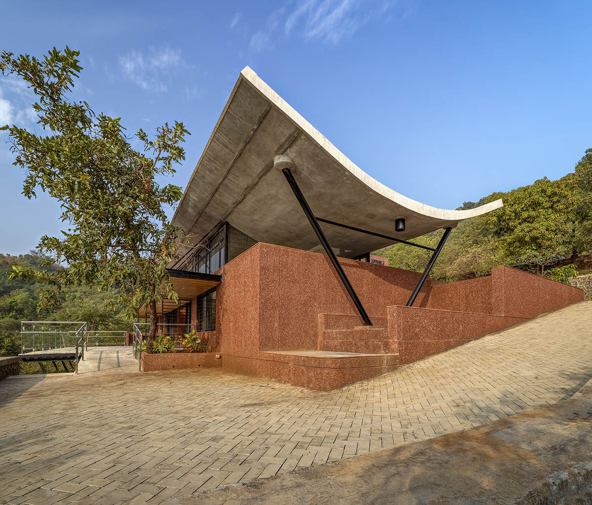 The Cove House by Red Brick Studio benefits from hilly slope and captures picturesque views in India