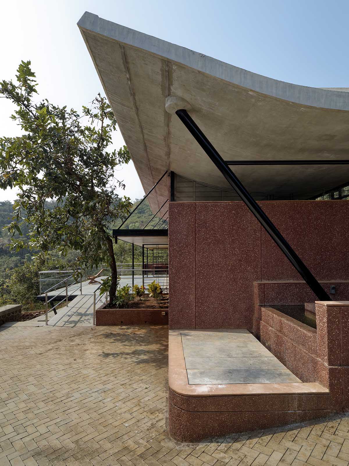 The Cove House by Red Brick Studio benefits from hilly slope and captures picturesque views in India