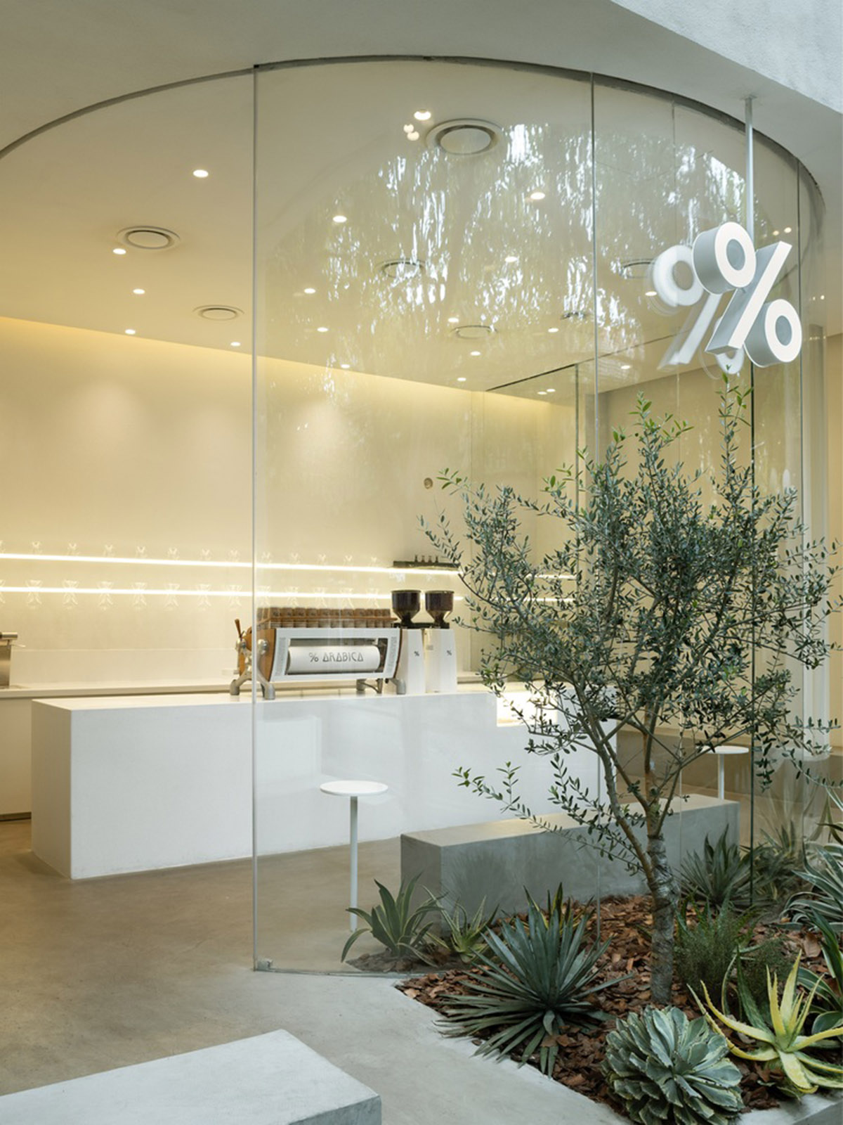 B.l.U.E. Architecture Studio designs this minimal coffee shop with glass frontage in Shanghai