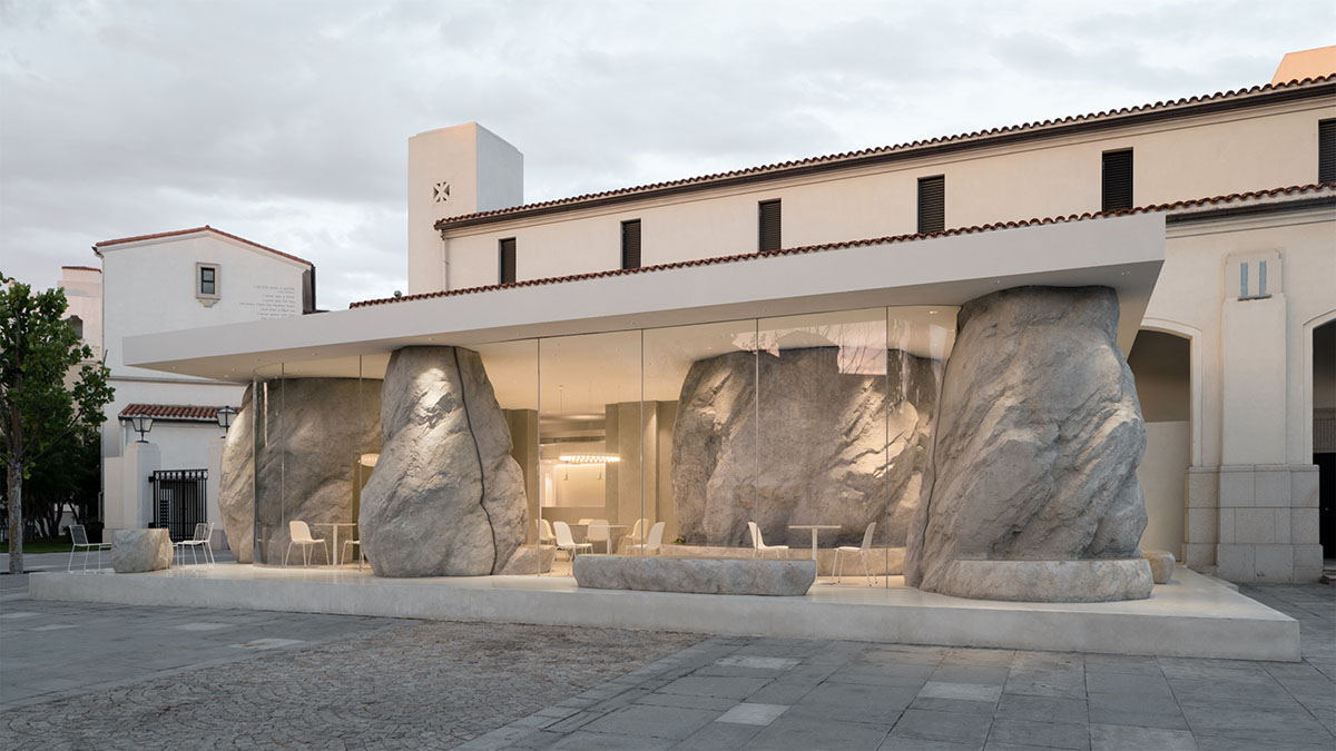 B.L.U.E. Architecture Studio adds a glazed cafe by using organic forms of stones to an open plaza