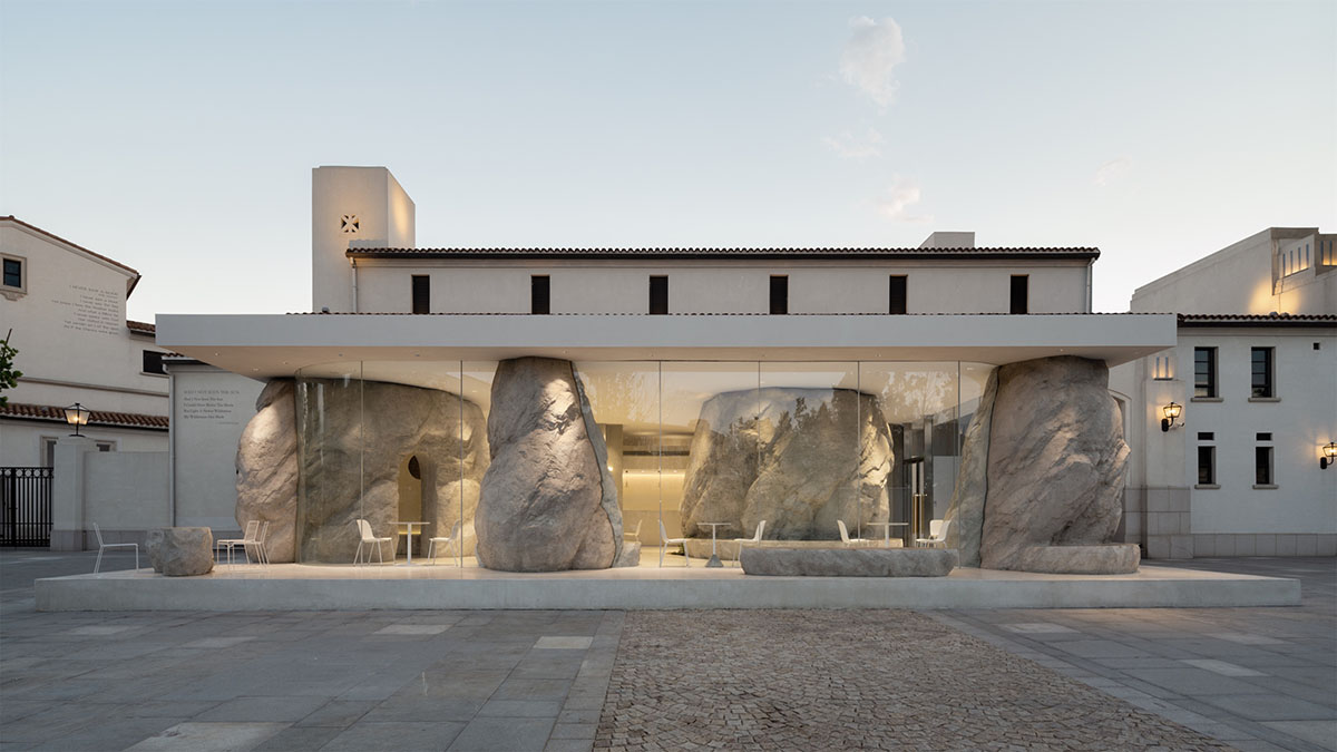 B.L.U.E. Architecture Studio adds a glazed cafe by using organic forms of stones to an open plaza