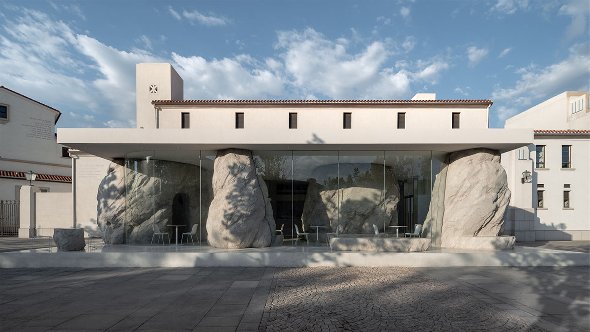B.L.U.E. Architecture Studio adds a glazed cafe by using organic forms of stones to an open plaza